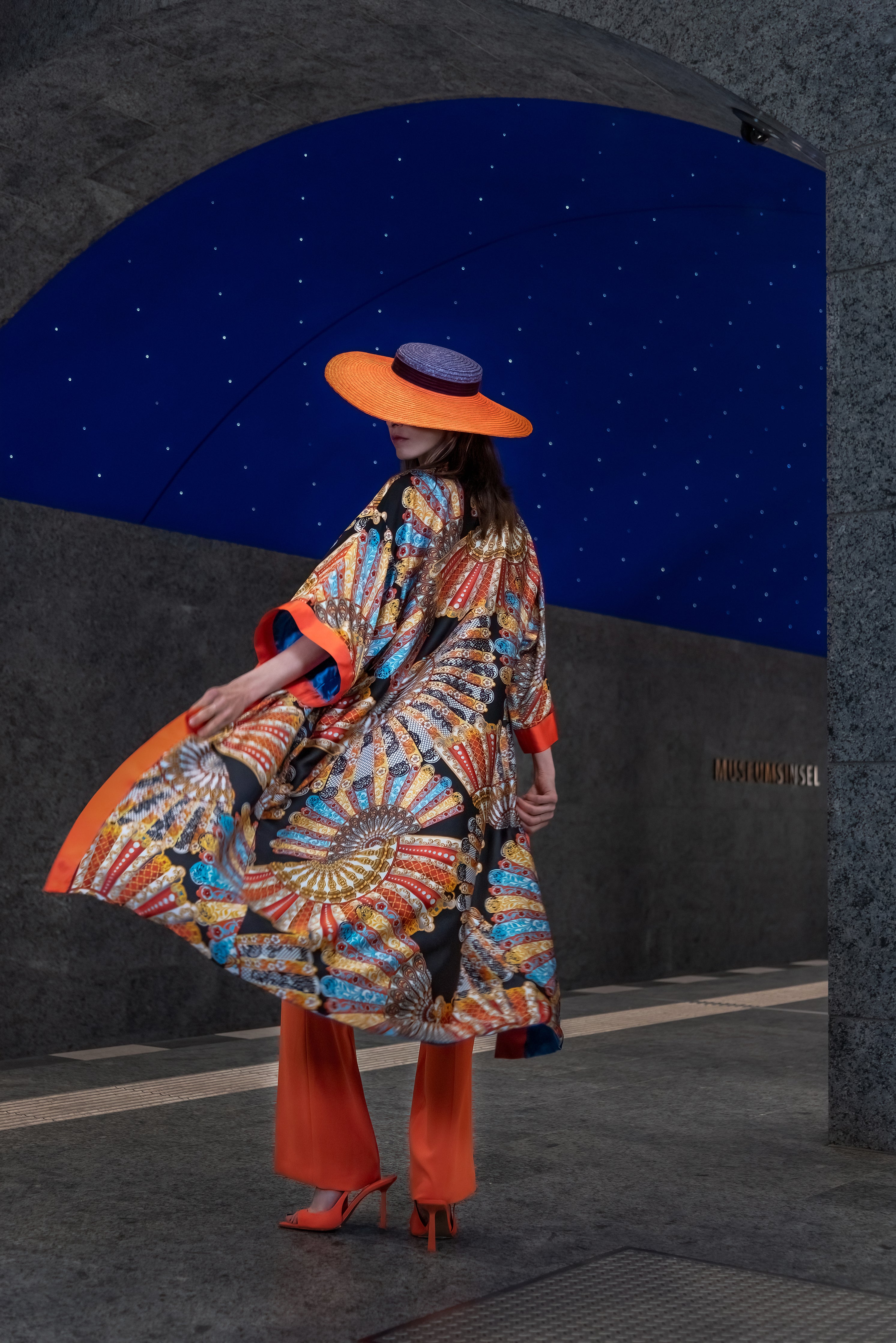 Model showcasing Fan Kimono back: vibrant fan pattern on mulberry silk.