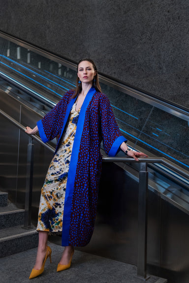 Model wearing Hallucinatory Polka Dream Kimono (bordeaux red & fluorescent blue polka dots).