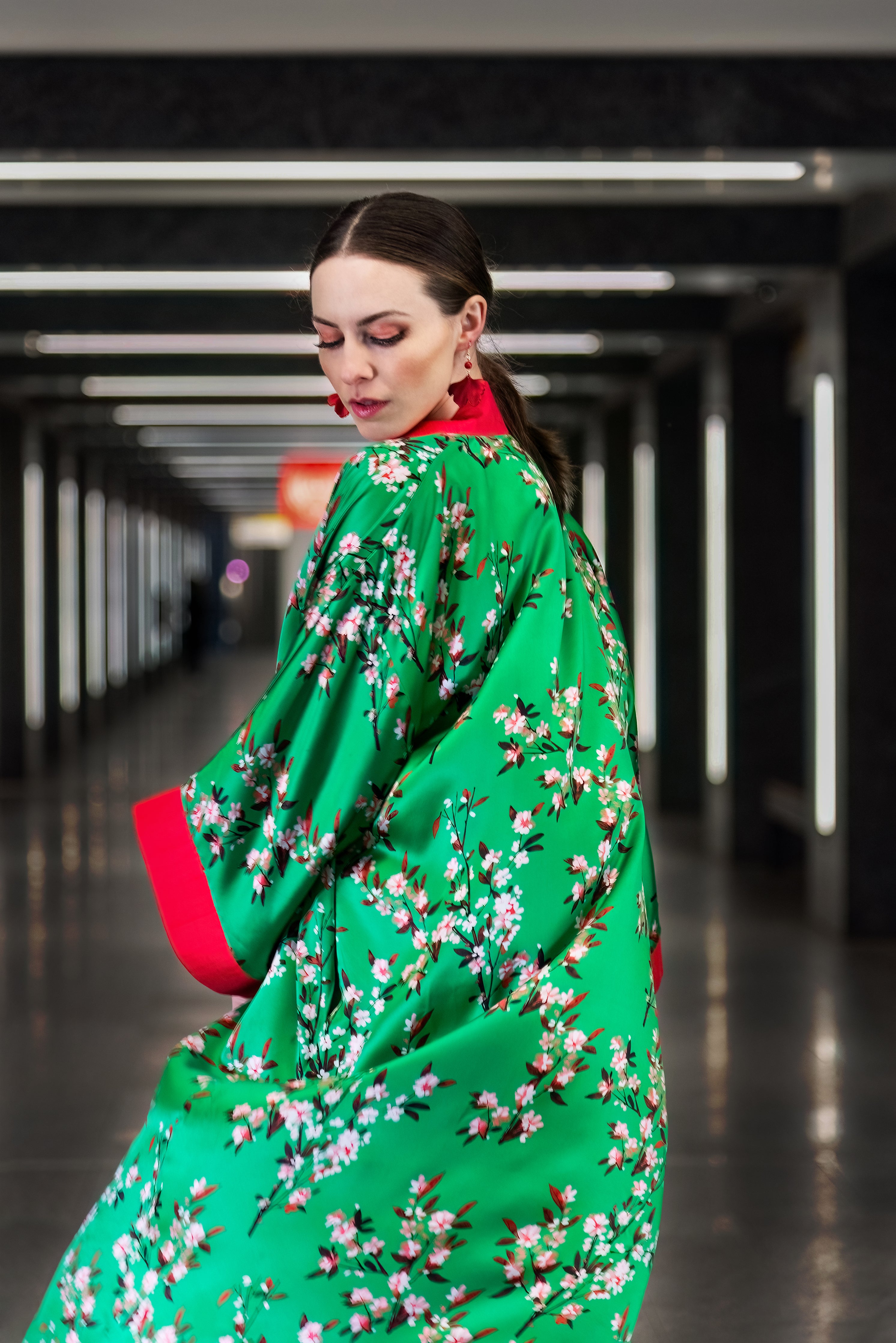 Close-up view of Cherry Blossom Kimono back: delicate blooms on green mulberry silk.