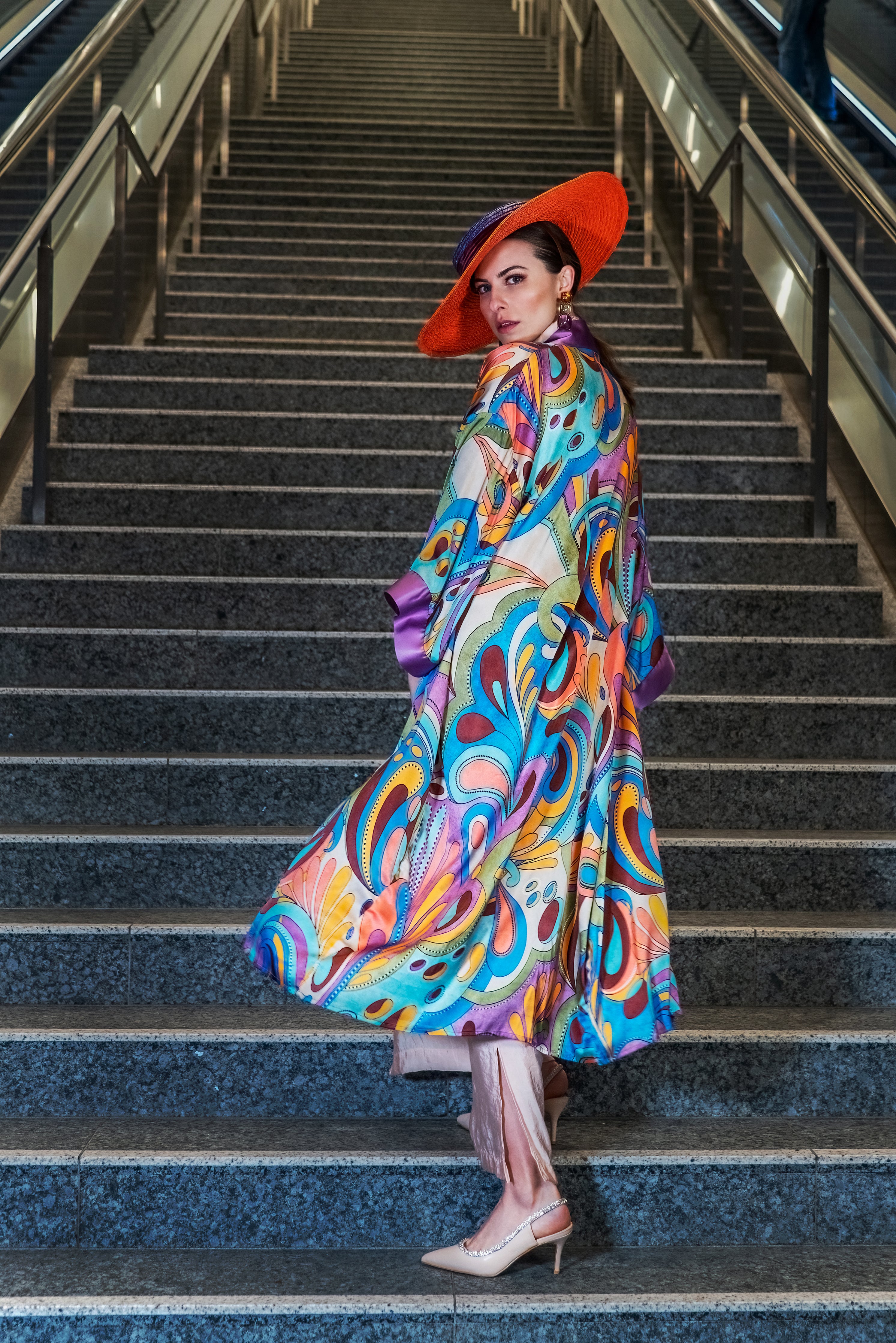 Model showcasing Rainbow Floral Kimono back: vibrant florals on soft mulberry silk.