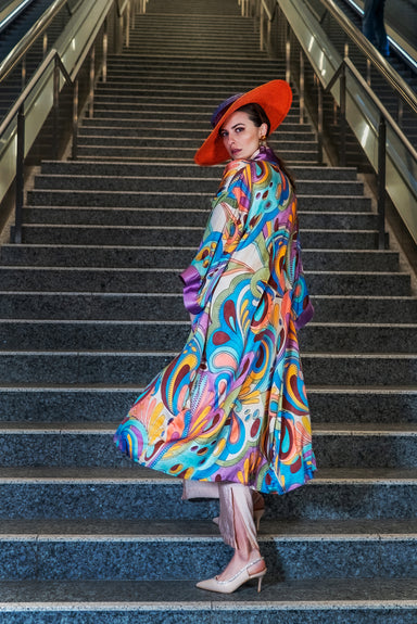 Model showcasing Rainbow Floral Kimono back: vibrant florals on soft mulberry silk.